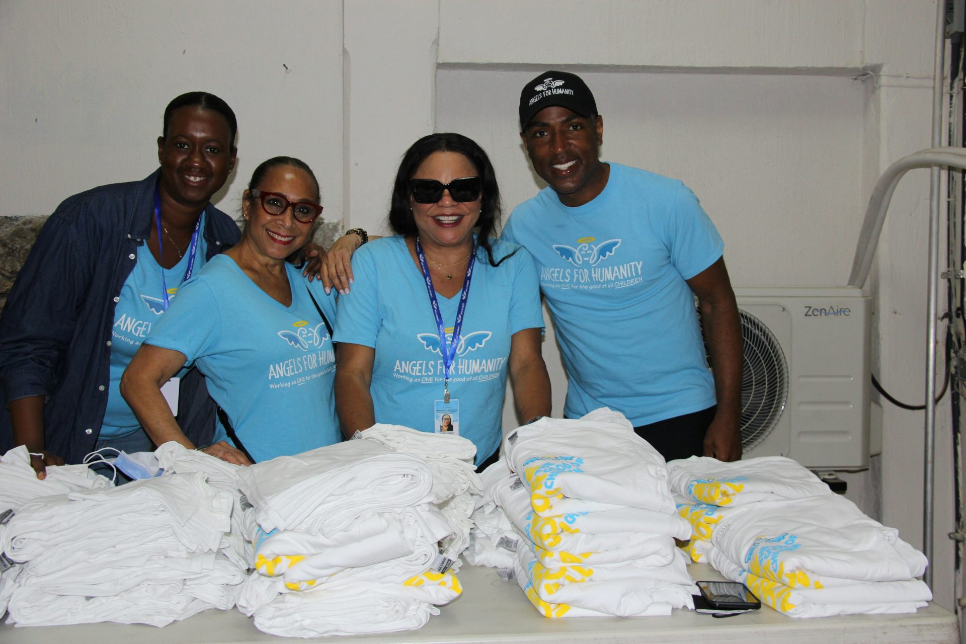 a group of people standing next to a pile of cloth