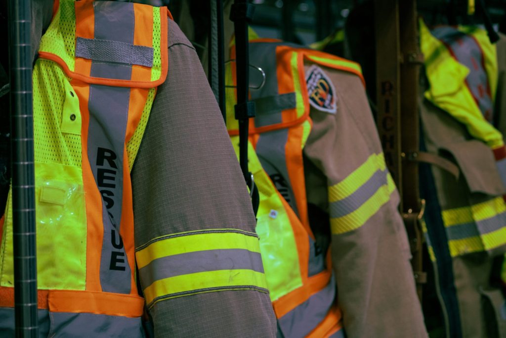 a row of vests that are on a rack